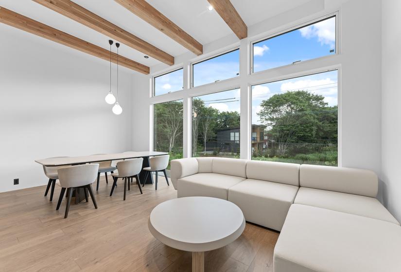 A lounge and dining table behind