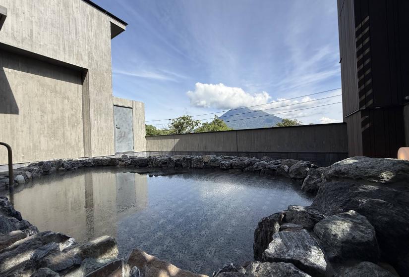 An onsen pool with mount Yotei behind