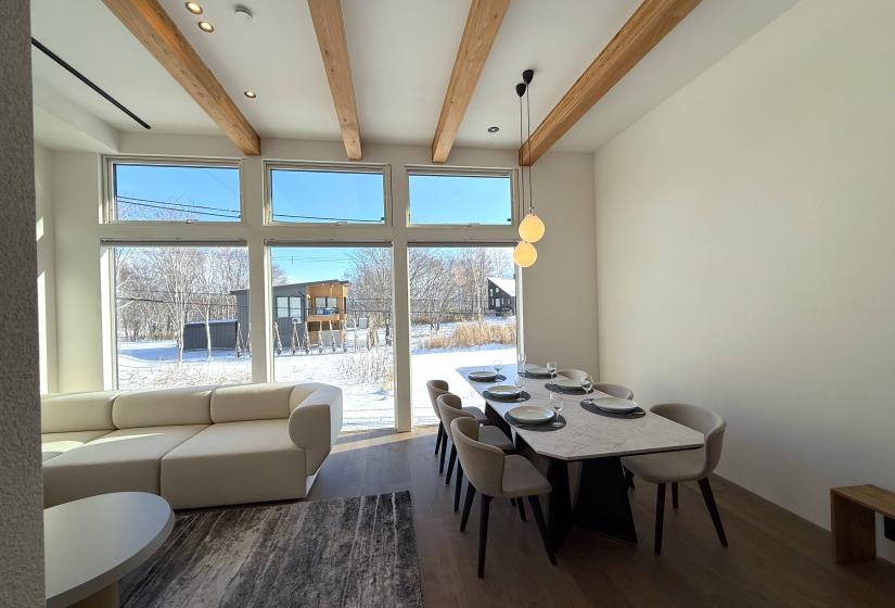 Dining table with large windows behind