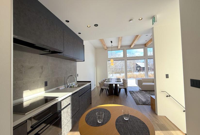 A kitchen and dining table behind