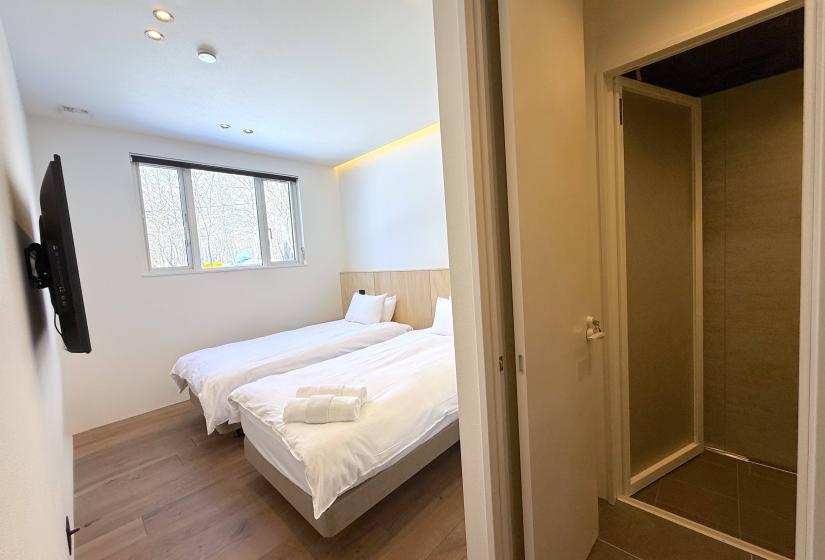 2 single beds with shower to the right