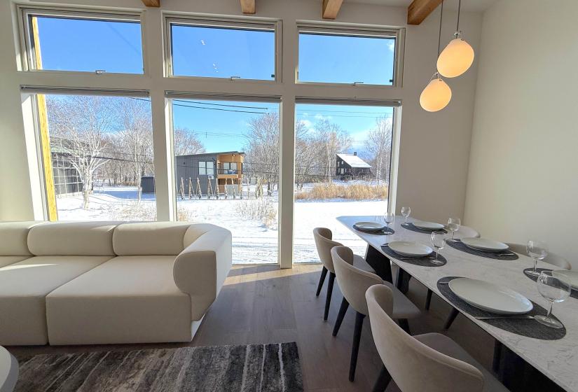 Dining table to the right large window behind