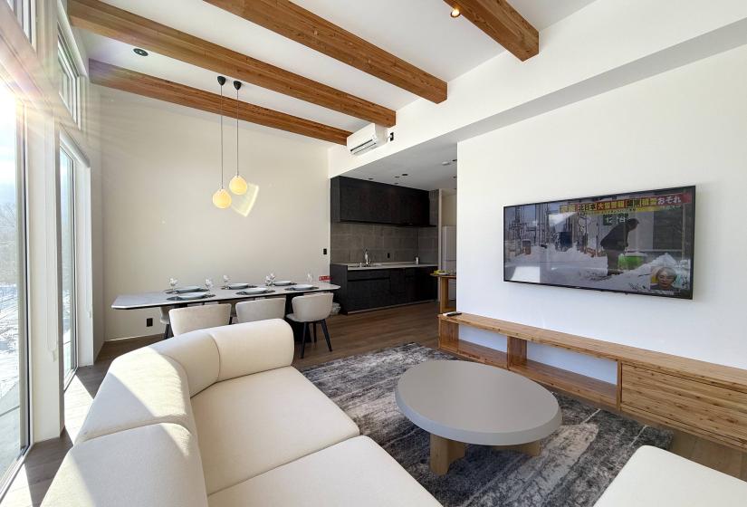 A crene sofa and TV to the right.