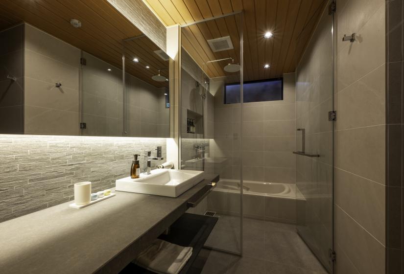 A bathroom sink with bath behind
