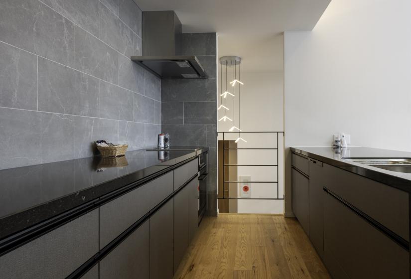 A long dark kitchen counter top