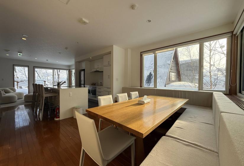 A dining table with and window behind
