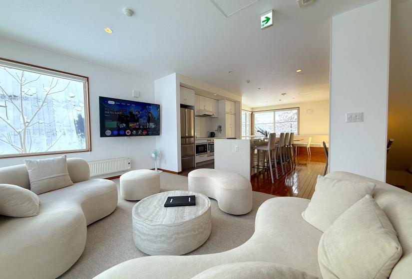 A curvy lounge suite with TV behind