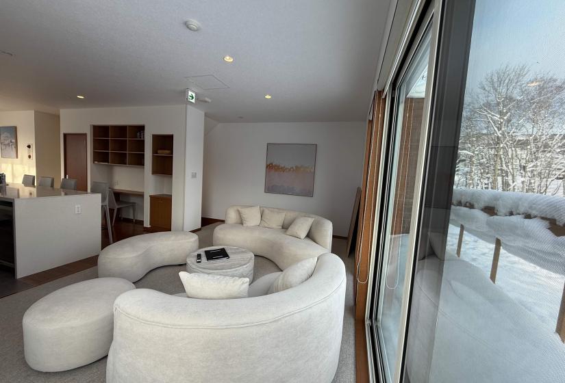 A curvy lounge suite with window to the right
