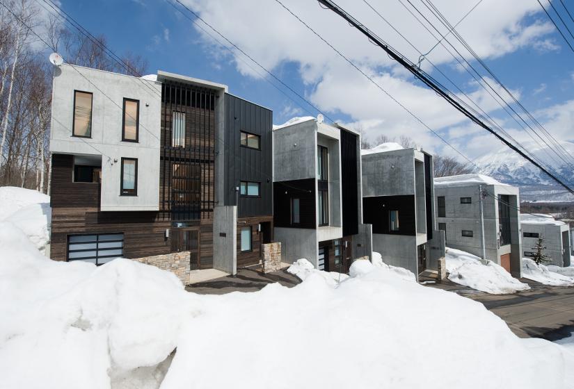 The exterior of 3 concrete townhouses