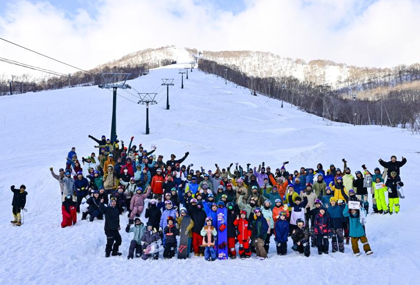A crowd of skiers and snowboarders on a ski slope