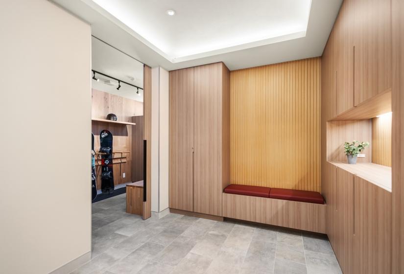 An entry way with shelf to the right and ski storage to the left