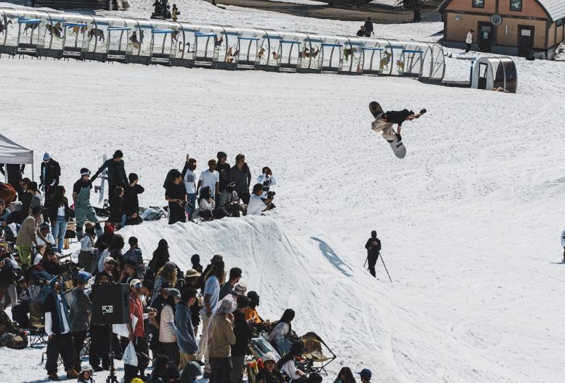 A snowboarder performs a method air