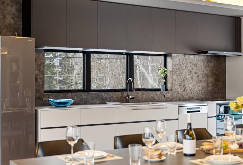 A set dining table and kitchen behind