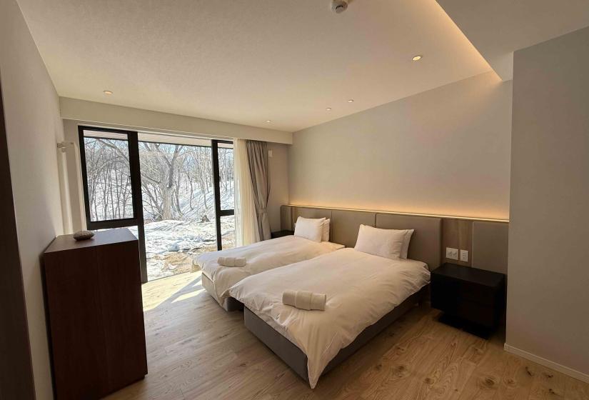Two single beds with towels at foot of beds