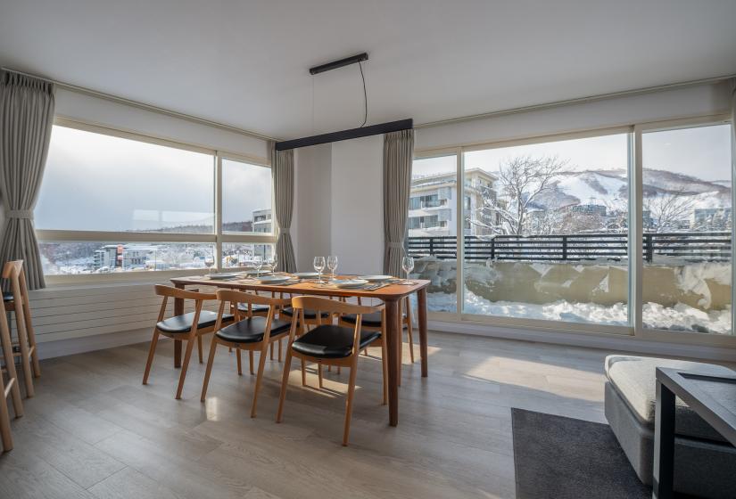 A dining table with mountain views behind      