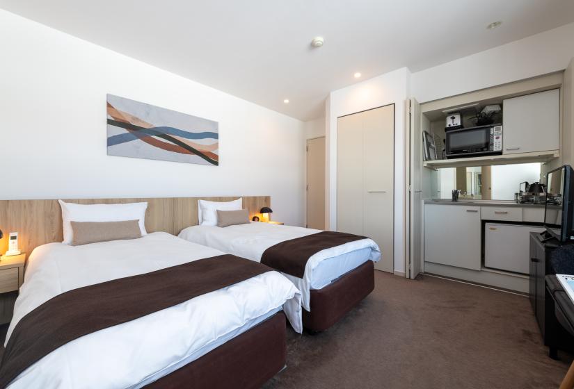 Two single beds with brown throw