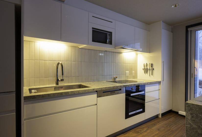 A kitchen bench with oven on the right of bench