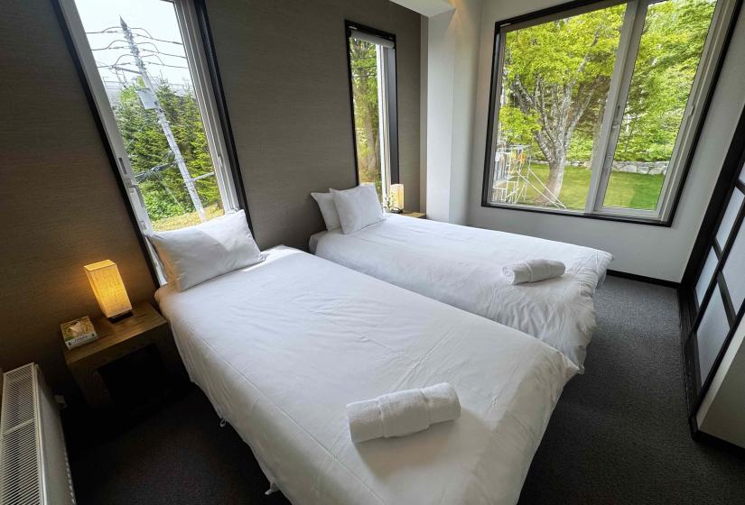 Two single beds with windows behind
