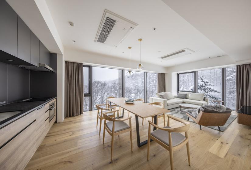 A dining table and kitchen to the left