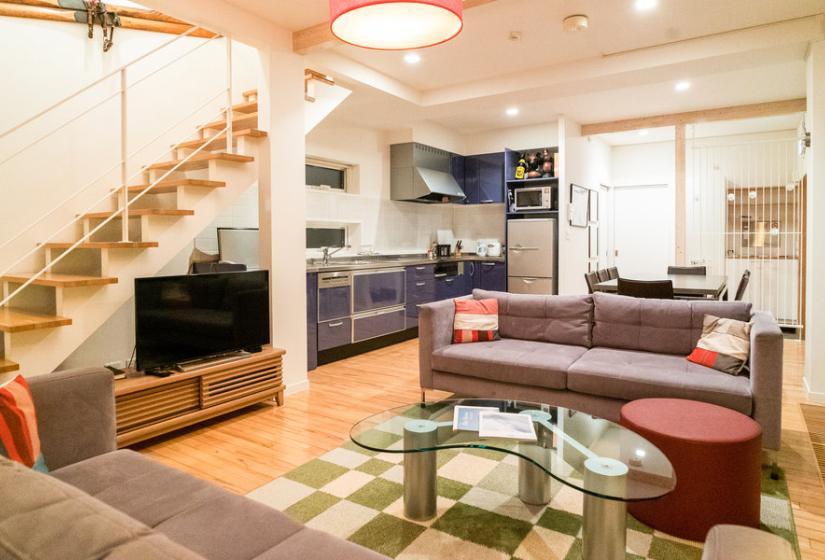 A living room with stairway to the left