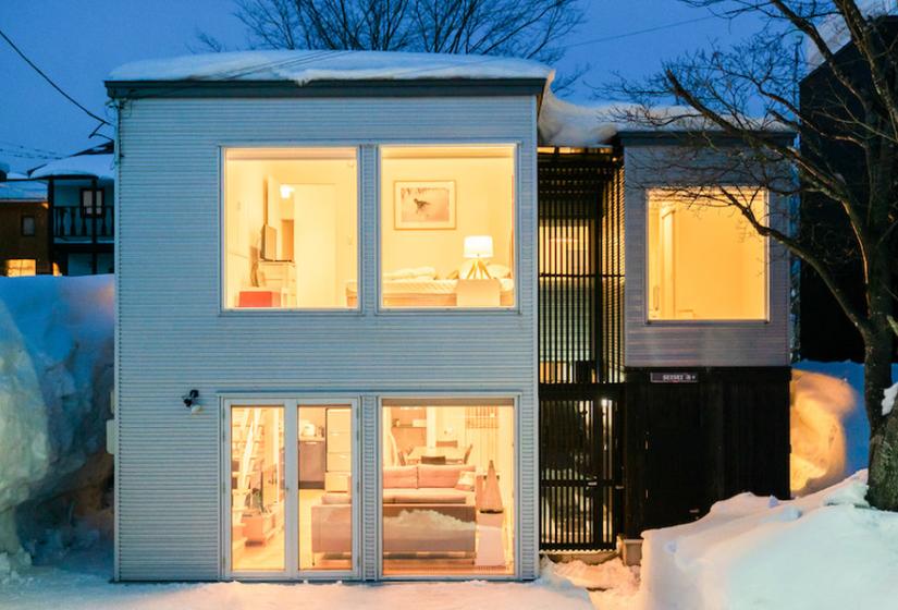 The exterior of a two story townhouse at night