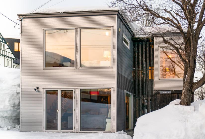 A two story town house surrounded by snow