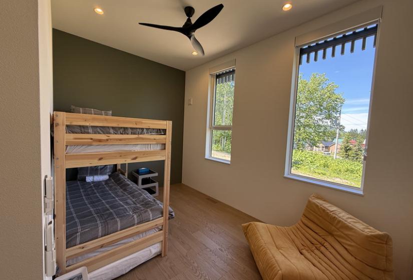 A bunk bed and tan colored chair