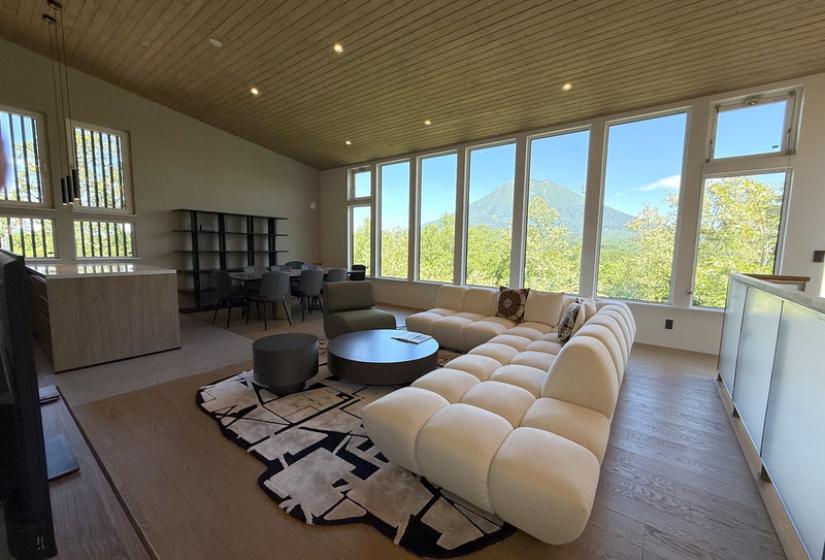 A cream puffy lounge suite with windows behind