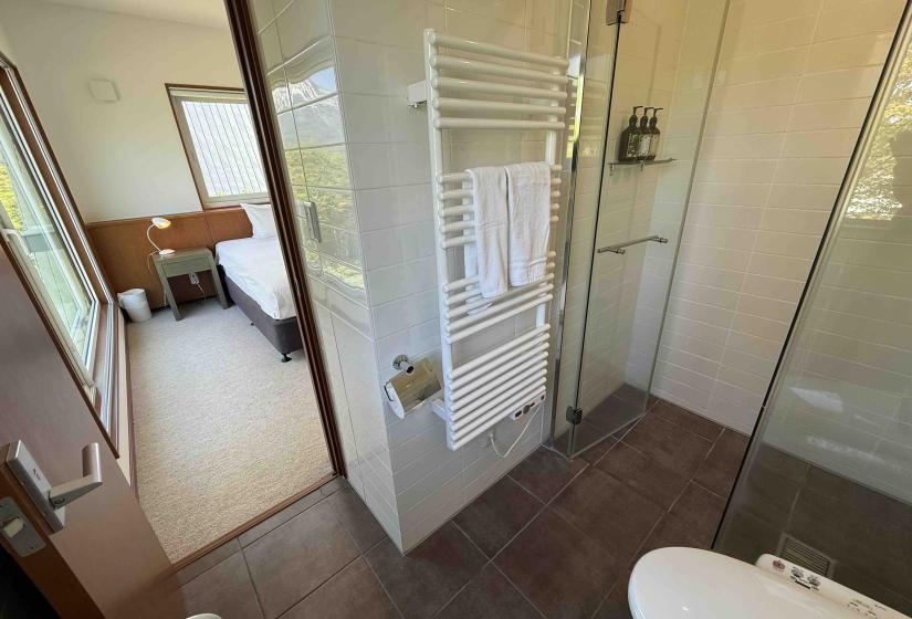 A bathroom with bedroom behind