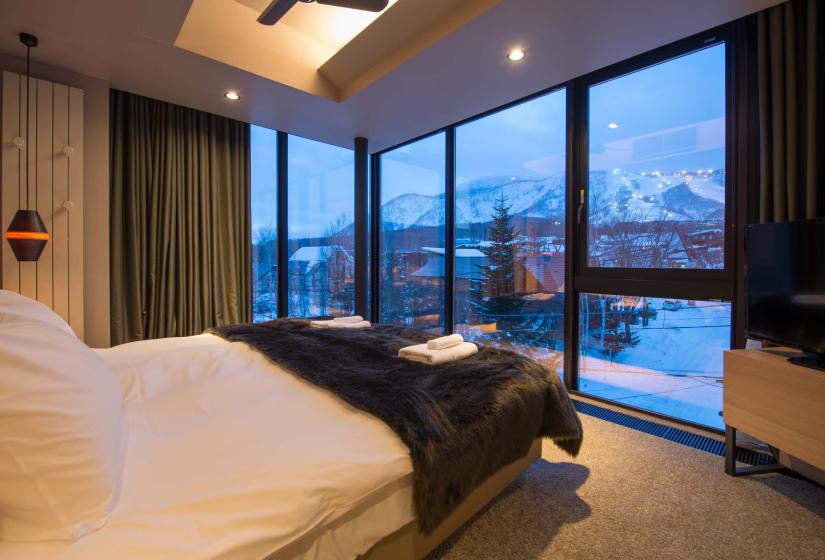 A view of a ski field from the foot of a bed