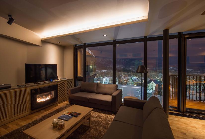 A lounge area with sofas and tv