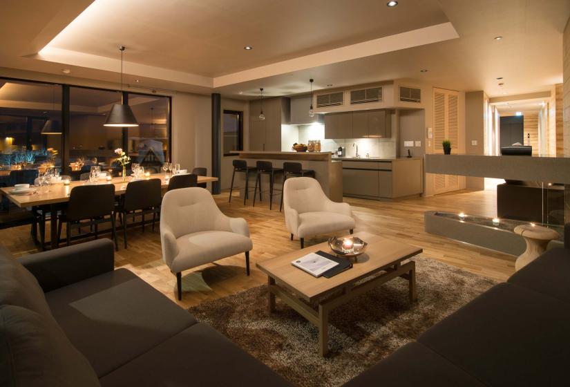 A living area with two white chairs