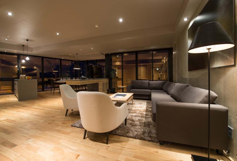 A lounge with light and two white chairs