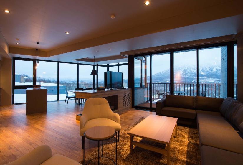 A lounge and dining area with mountain views