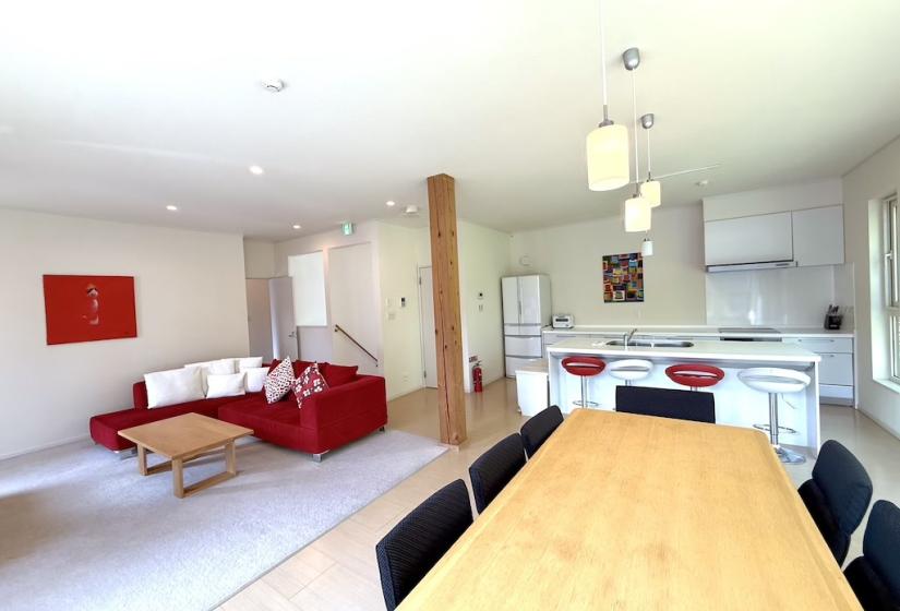 A dining table and kitchen behind