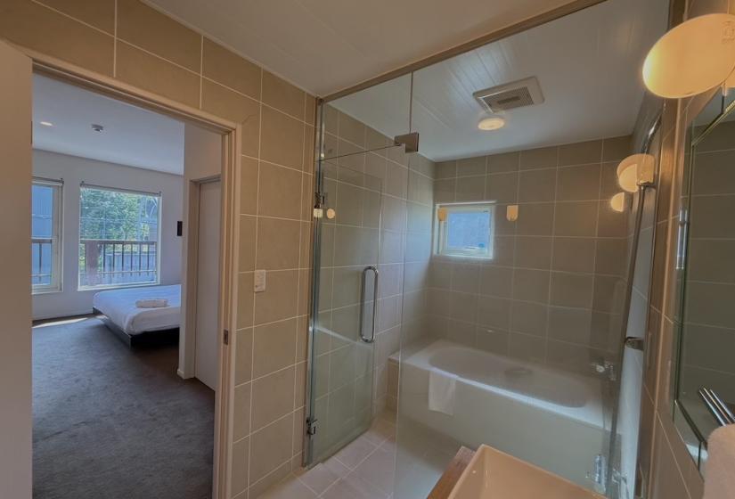 A bathroom with bedroom visible through door