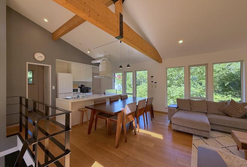 A grey lounge suite and bench behind
