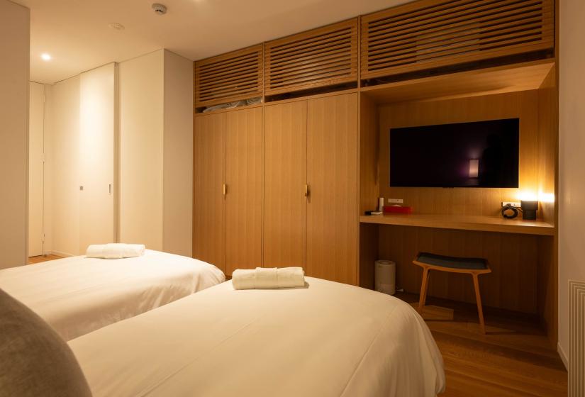 Bedroom with two beds and tv