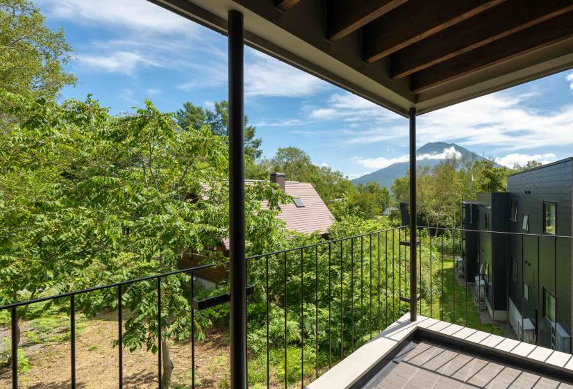 Setsuei Niseko balcony view of summer forest and Mt Yotei