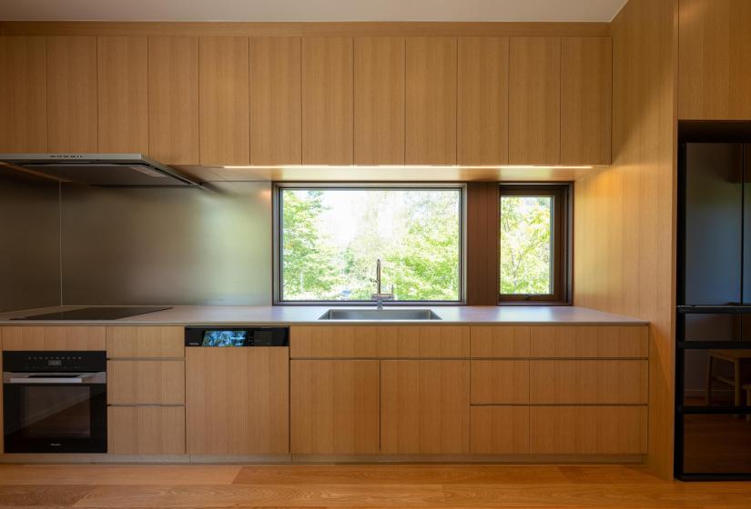 Setsuei Niseko kitchen with Miele oven, dishwasher and forest-view window