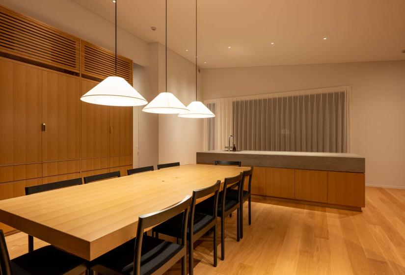 Oak dining table for ten under pendant lights, Setsuei Niseko